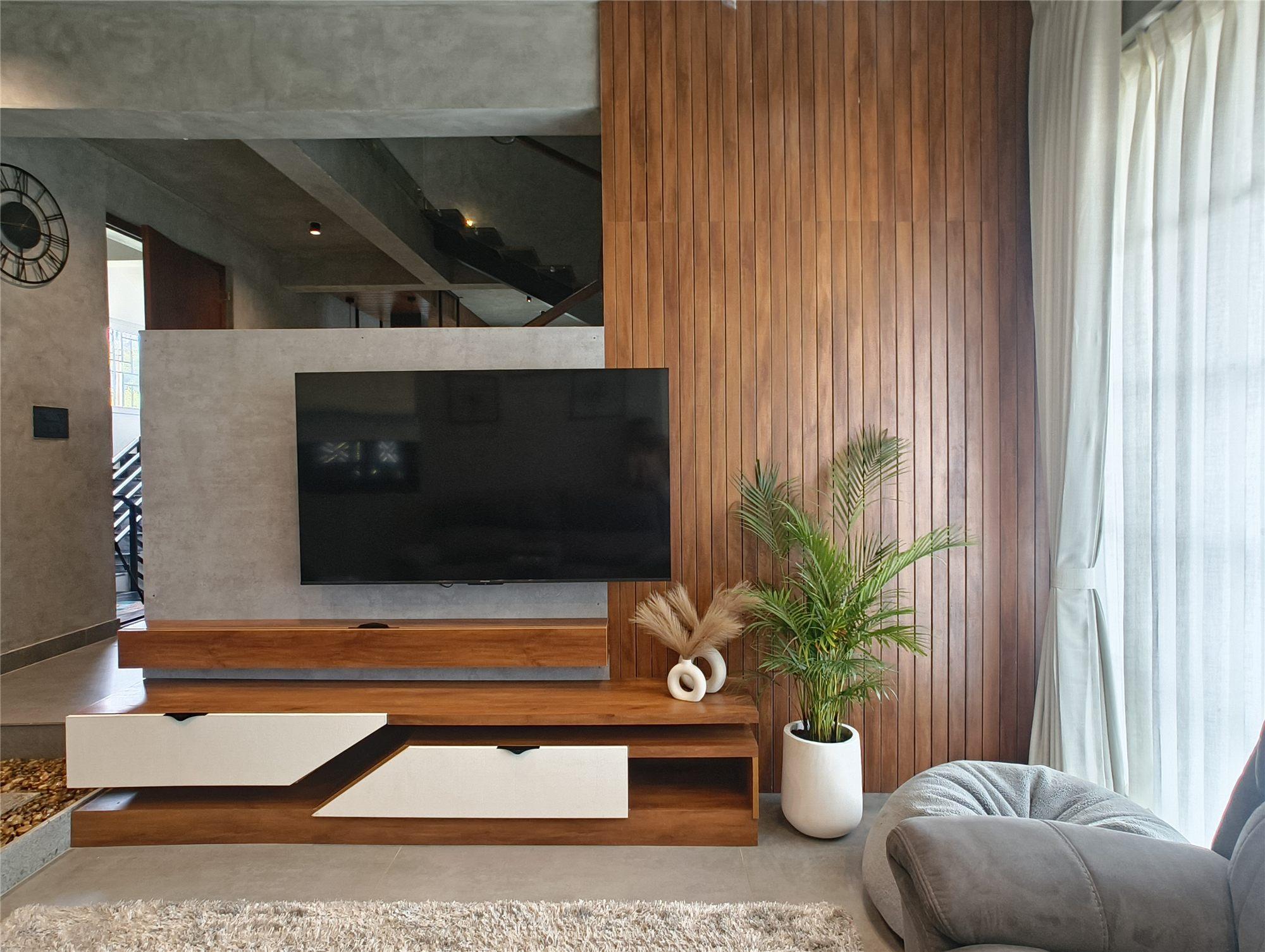 Gubbi Gudu villa, Anjanapura, Bangalore — walnut TV unit with angled white fronts beside the fluted wood rafters