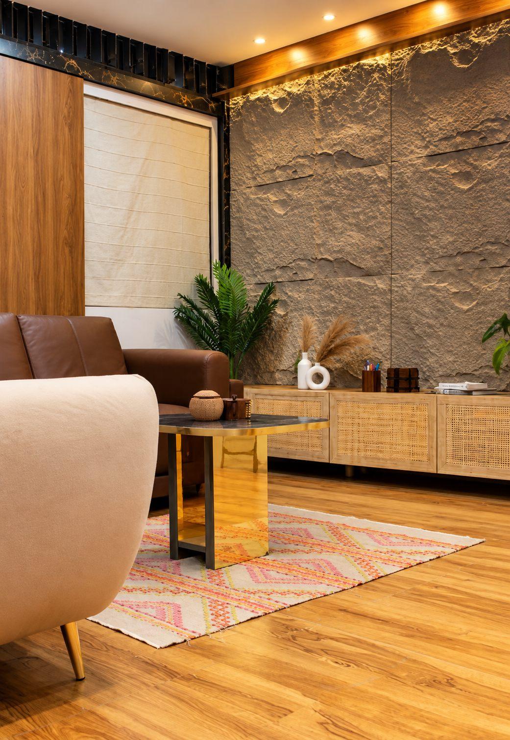 Lounge in Willow’s display studio with a stone-texture feature wall, wood panelling and a cane sideboard
