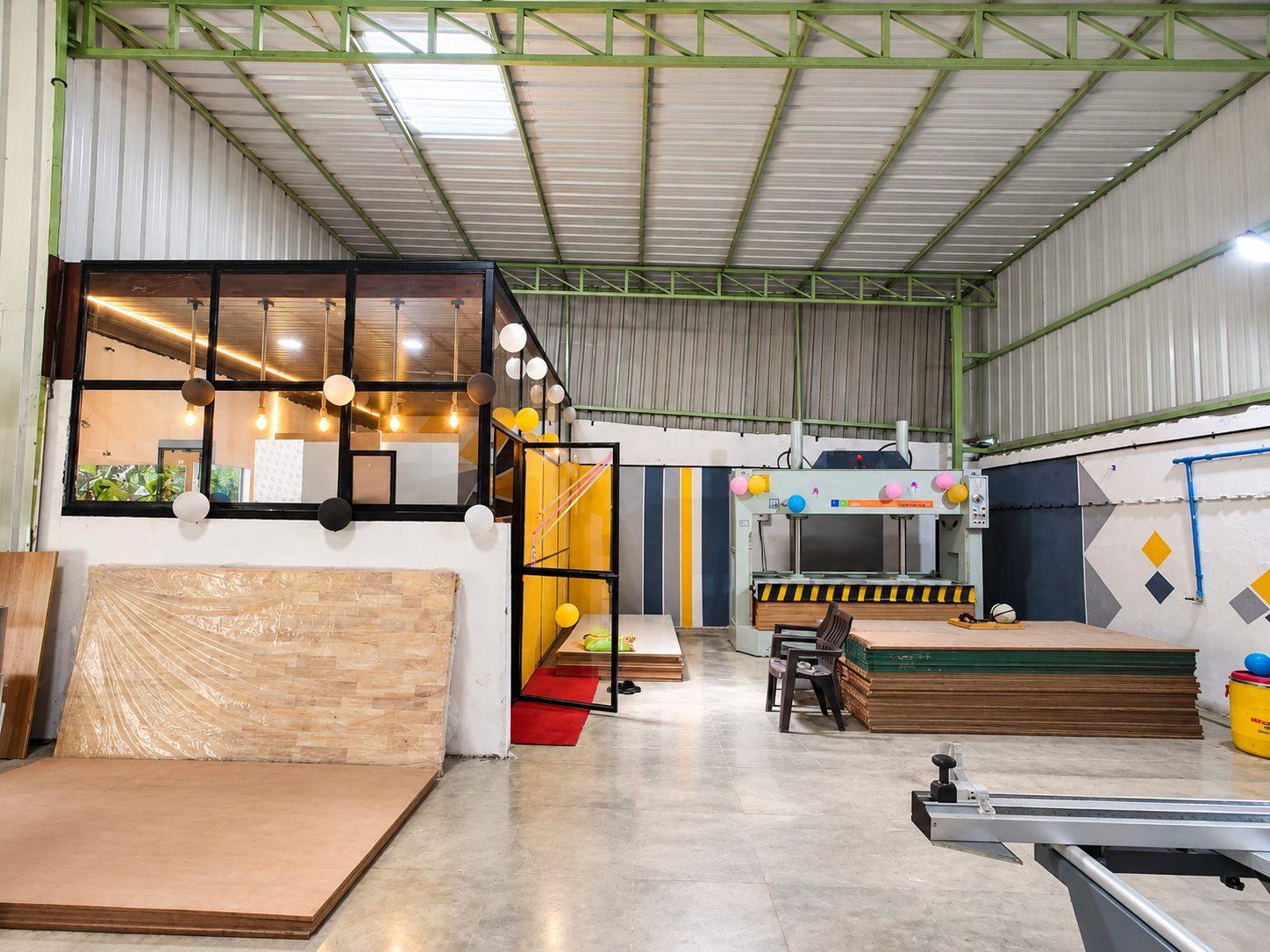 Willow manufacturing unit floor with a glass-walled display area, board stock and a panel saw