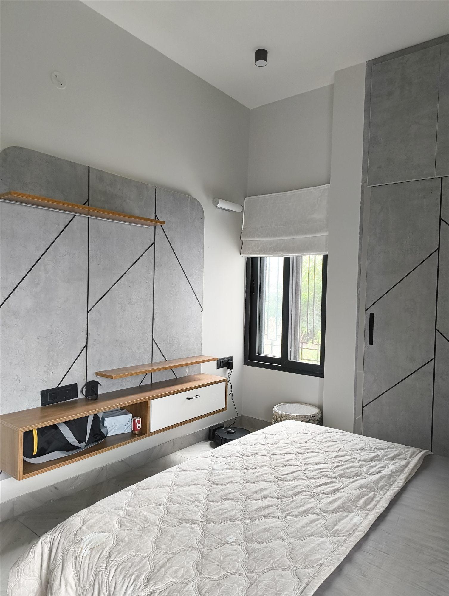 Gubbi Gudu villa, Anjanapura, Bangalore — parents’ bedroom TV unit with grey wall panels