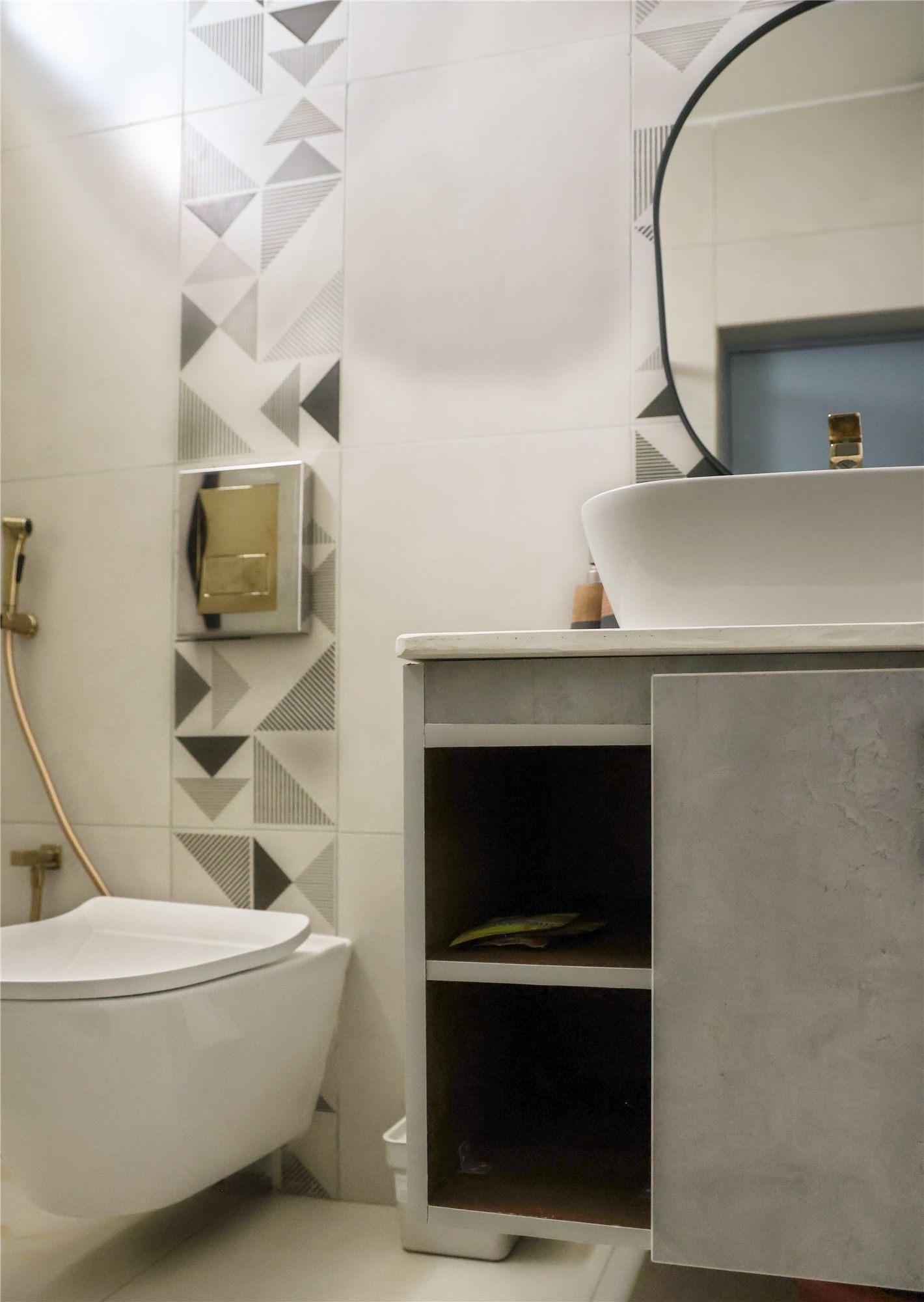 Gubbi Gudu villa, Anjanapura, Bangalore — powder room with geometric tiles and a wall-hung vanity