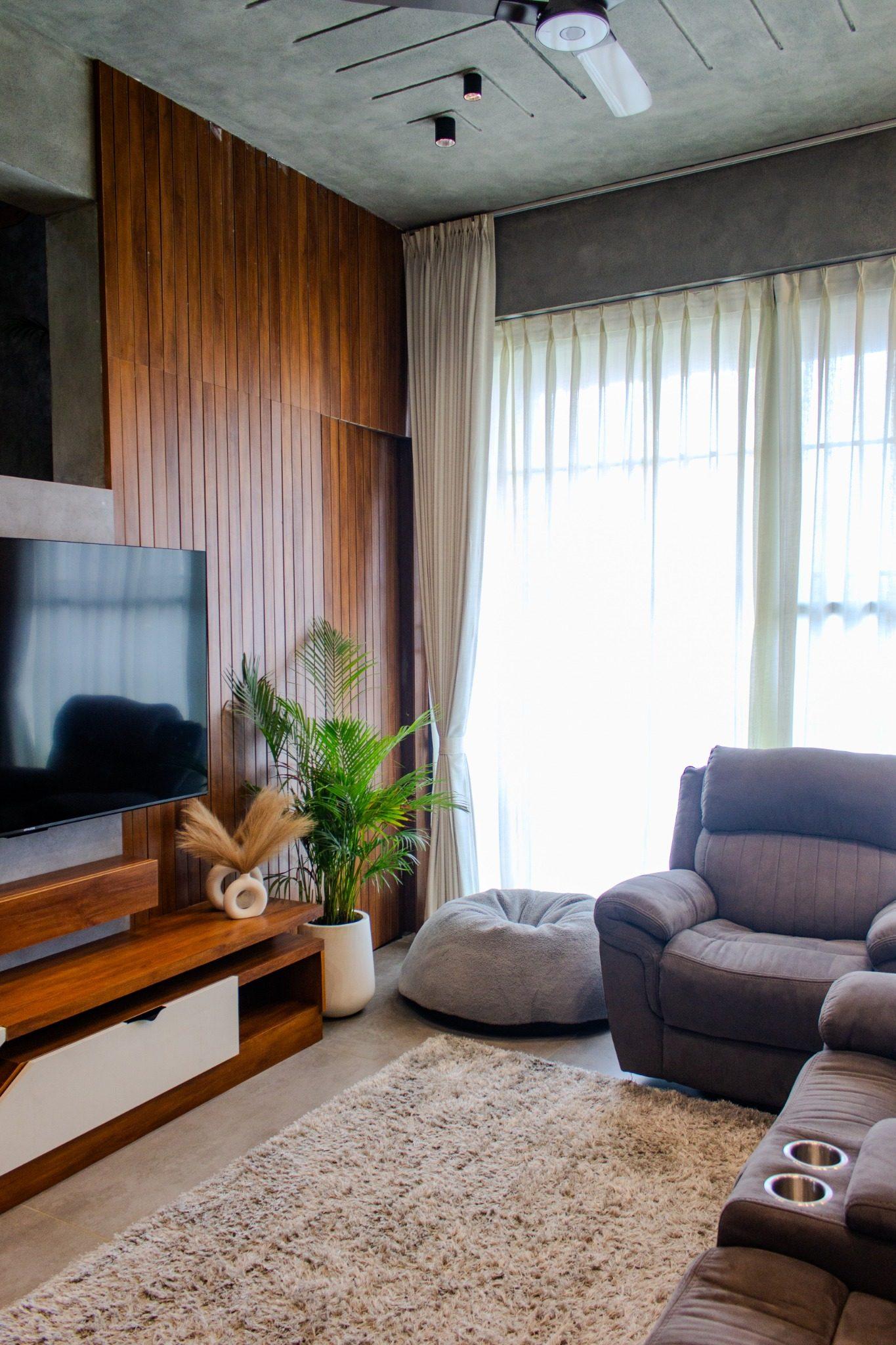 Gubbi Gudu villa, Anjanapura, Bangalore — living room with walnut TV unit, fluted wood wall and sheer full-height curtains