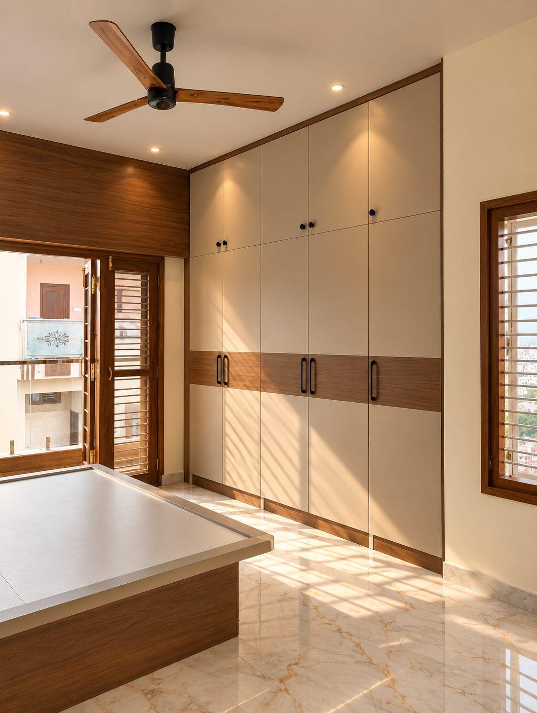 Master bedroom wardrobe in ivory with a walnut band — Saral Mane, a G+2 house on Kanakapura Road, Bangalore