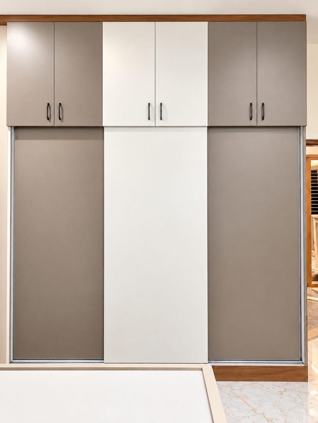 Parents’ bedroom sliding wardrobe in taupe and white — Saral Mane, a G+2 house on Kanakapura Road, Bangalore