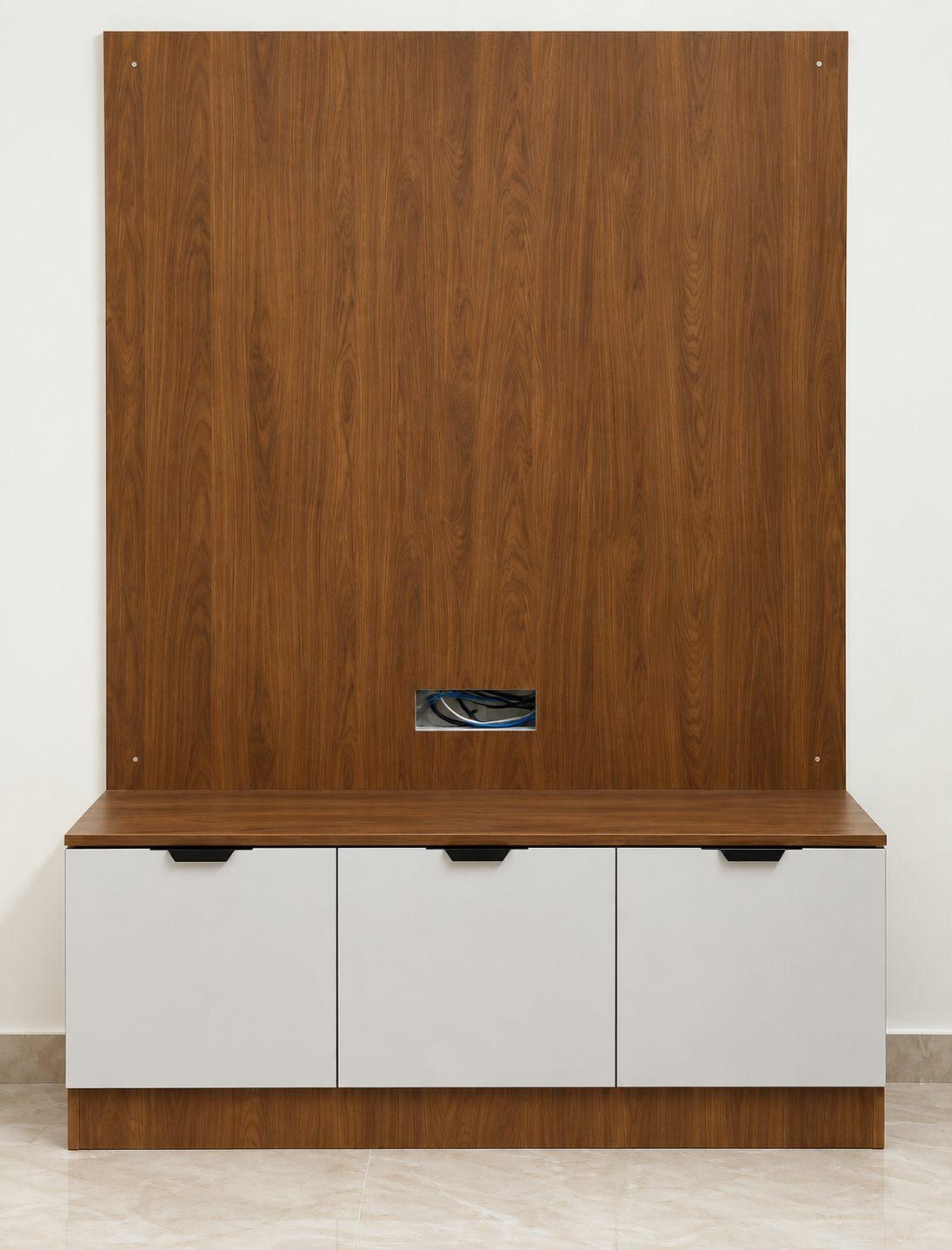 Wooden TV wall panel above white base cabinets on a wooden plinth