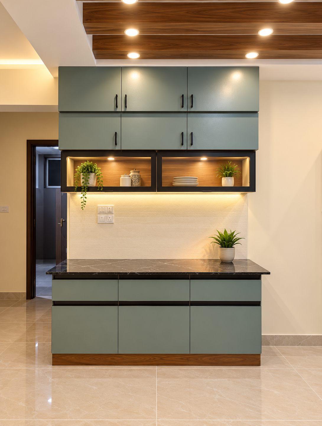 Sage-green crockery unit with black granite top, lit open niche and wooden ceiling rafters, in Sage & Sunshine, an apartment on Sarjapur Road, Bangalore